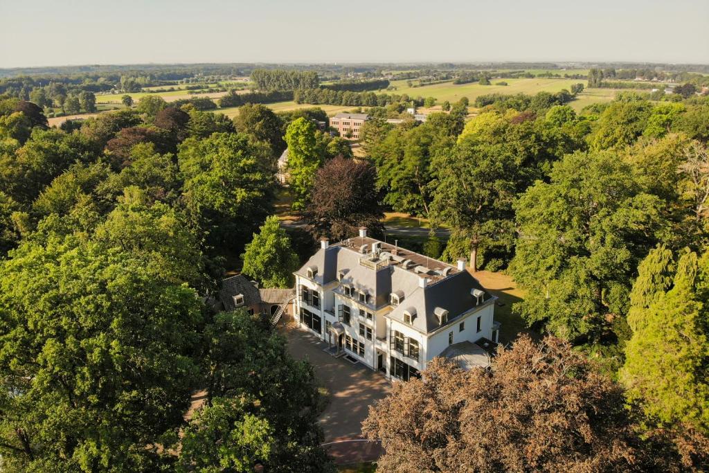 an aerial view of a house in the woods at Landgoed de Horst in Driebergen