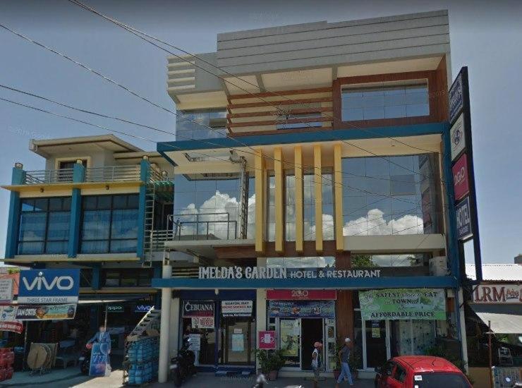 a building on a street with people walking in front of it at RedDoorz @ Bansud Oriental Mindoro in Bansud