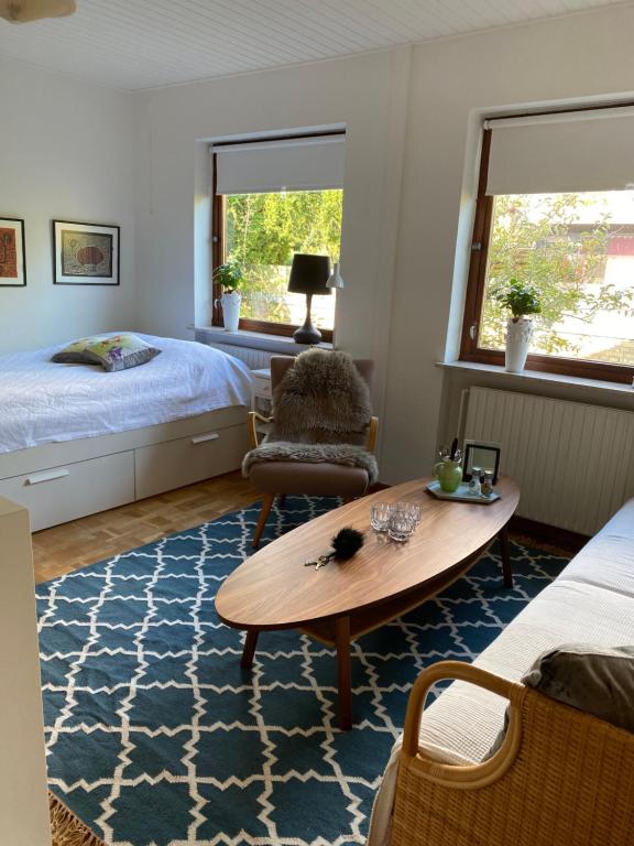 a bedroom with a bed and a table and a chair at Guesthouse Jensen Aarhus in Risskov