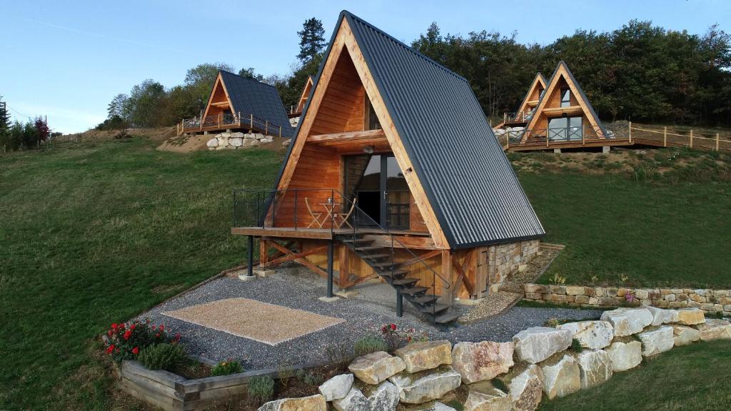 a cabin with a metal roof on a hill at Ô TIPI LODGE in Saint-Christo-en-Jarez
