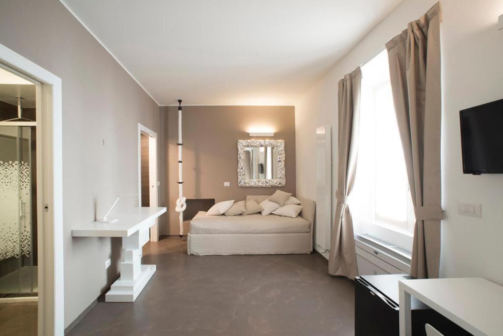 a white bedroom with a bed and a sink at L'Ottava GuestHouse in Milan