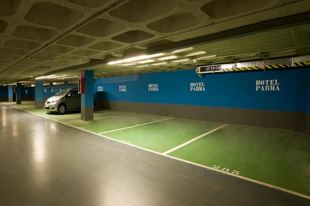 a car parked in a parking garage with a tennis court at Hotel Parma in San Sebastián