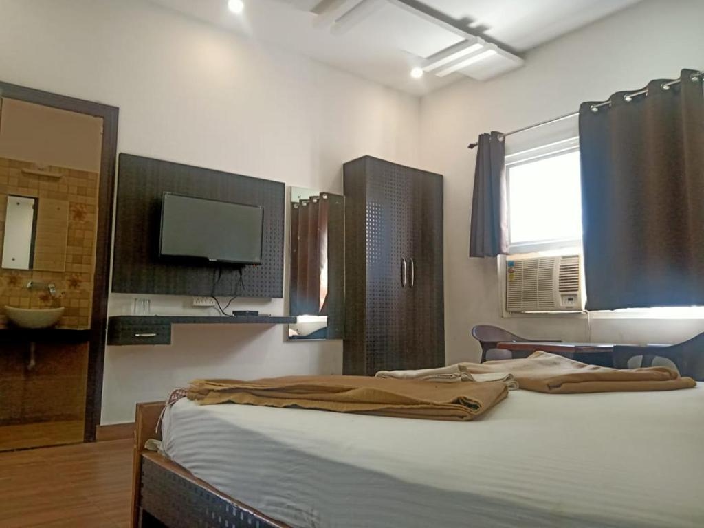 Postel nebo postele na pokoji v ubytování Hotel Rajshree
