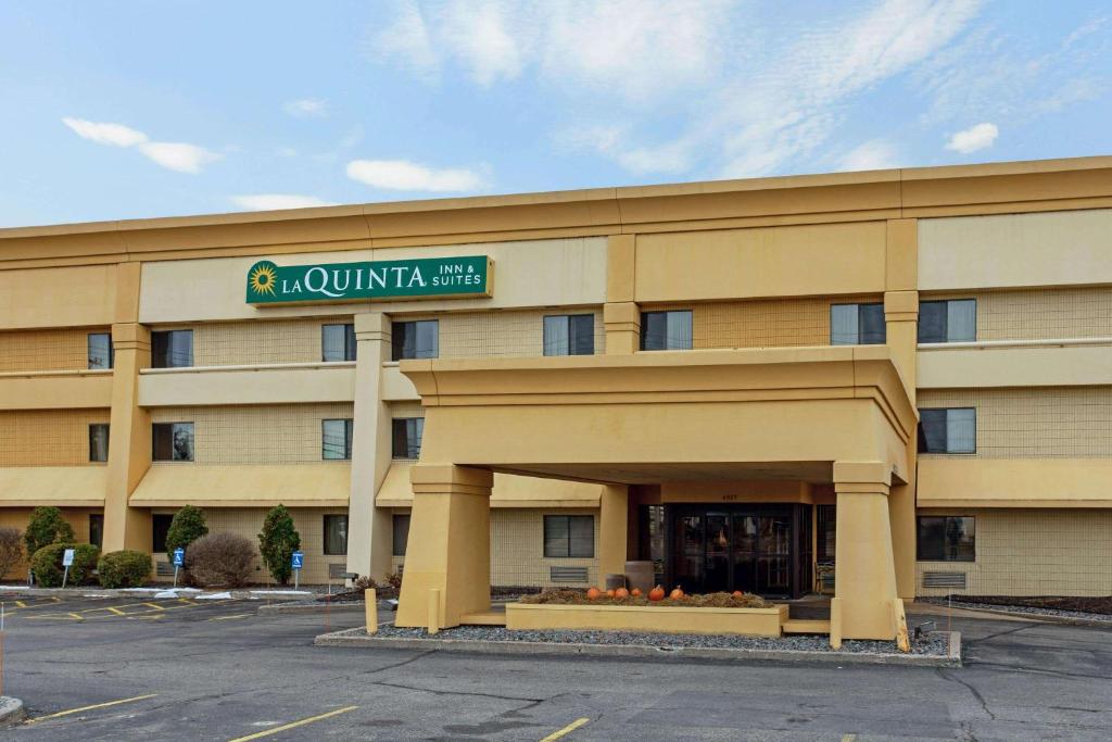 a hotel building with a sign on the front of it at La Quinta by Wyndham Stevens Point in Stevens Point