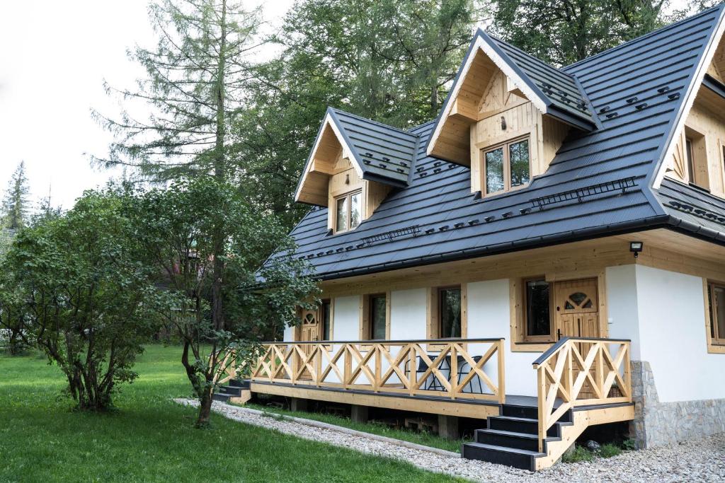 a house with a black metal roof at Dziadek Władek in Zakopane