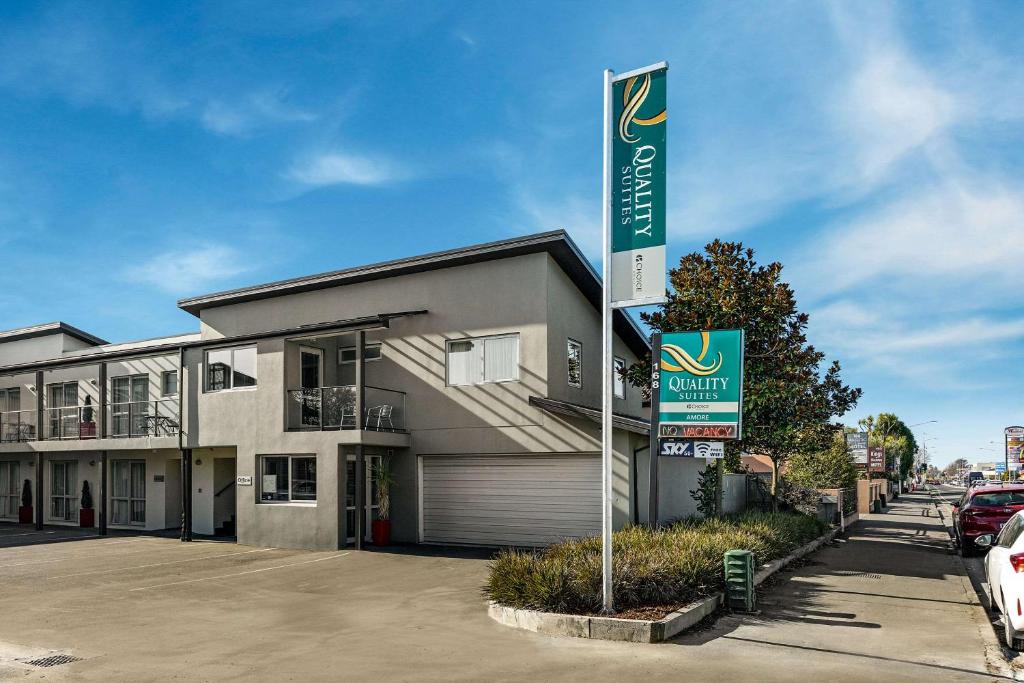 a building with a sign in front of it at Quality Suites Amore in Christchurch