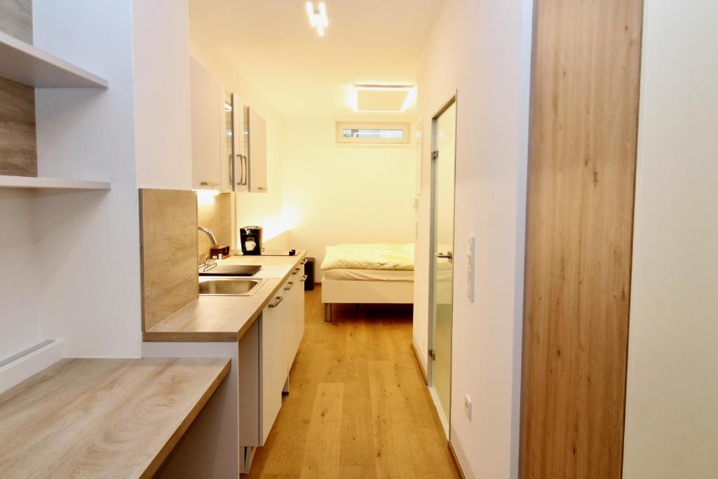 a kitchen with a sink and a bed in a room at Central STUDIO WORK and TRAVEL in Vienna