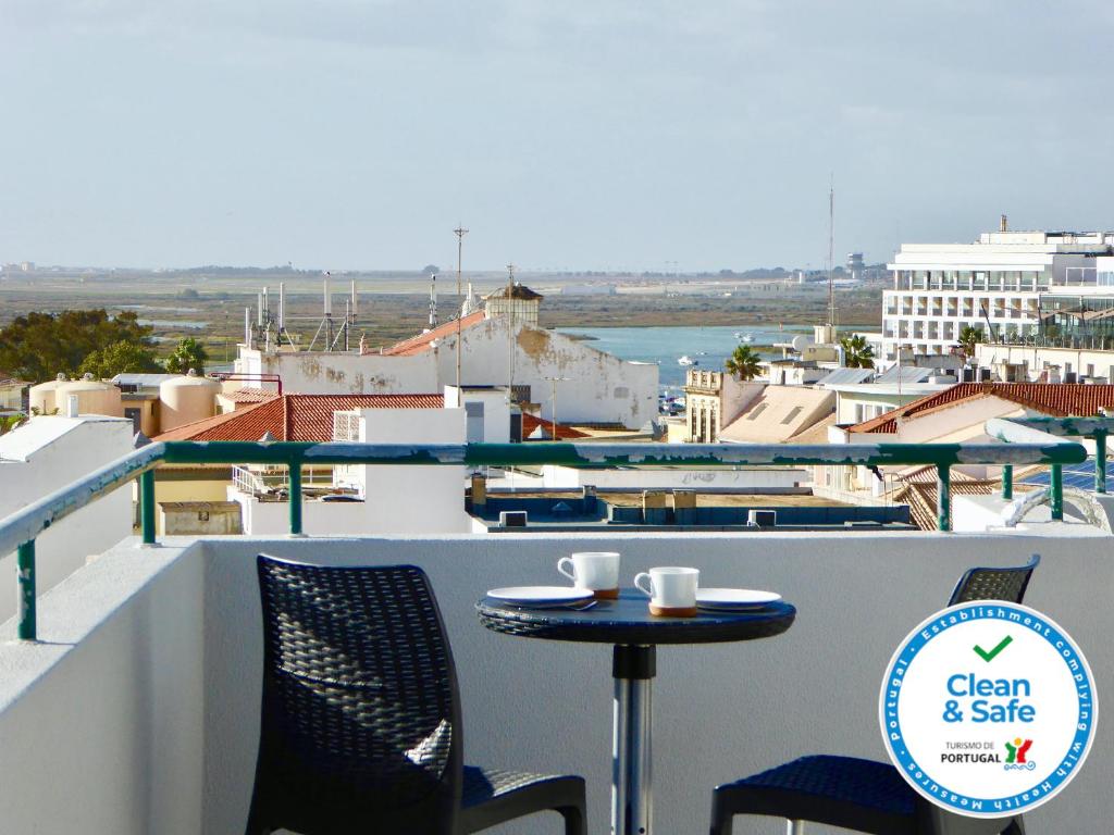 a table and chairs on a balcony with a view at Downtown by Check-in Portugal in Faro
