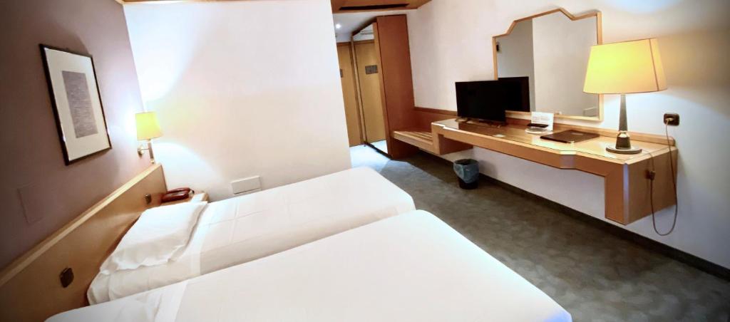 Postel nebo postele na pokoji v ubytování Hotel Ca' Brugnera