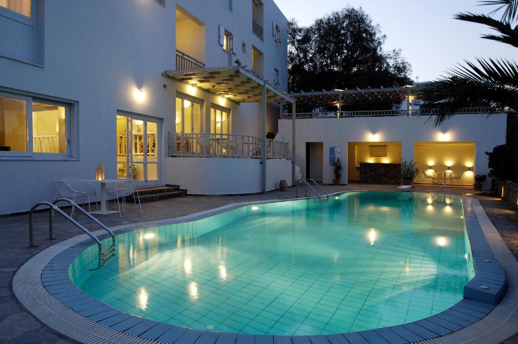 a swimming pool in front of a house at Filoxenia Apartments in Agia Pelagia Kythira
