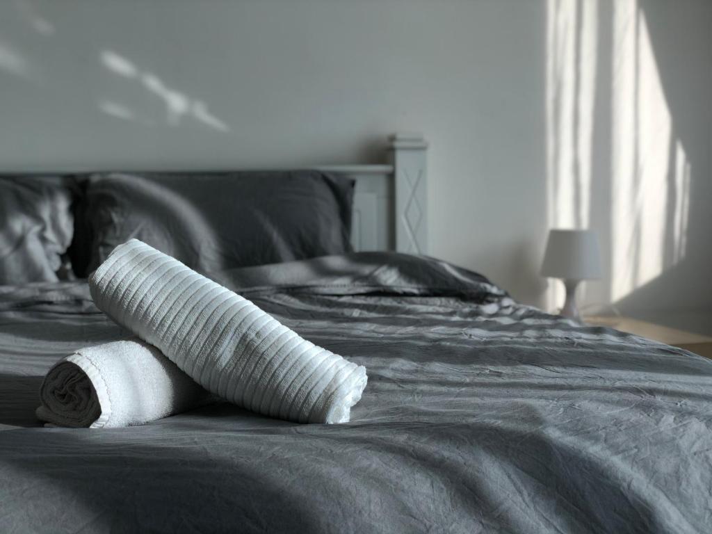 a stack of towels sitting on top of a bed at Cloud Stay at Setia Alam in Shah Alam