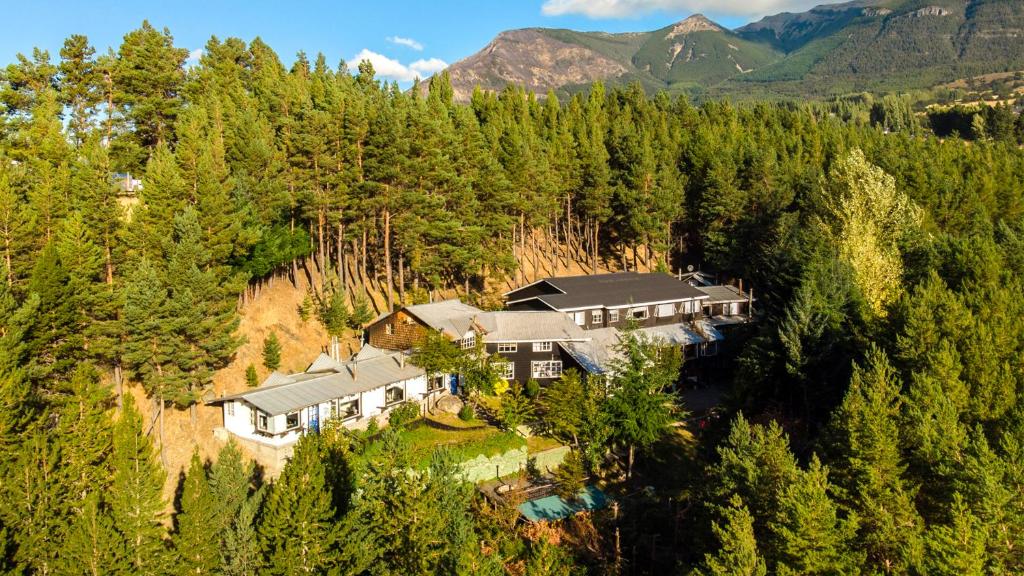 an aerial view of a house in a forest at The Patagonian Lodge in Coihaique