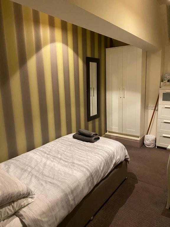 a bedroom with a bed and a dresser at The Stag in Northwood