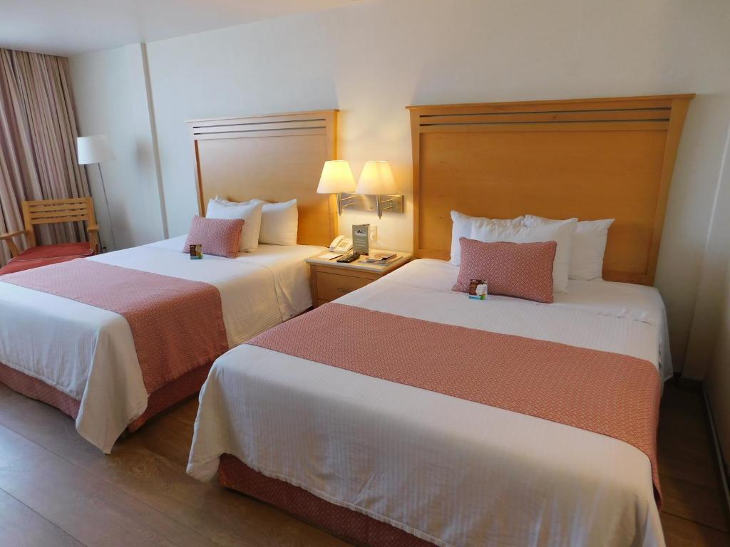 Postel nebo postele na pokoji v ubytování Hotel Palacio Azteca
