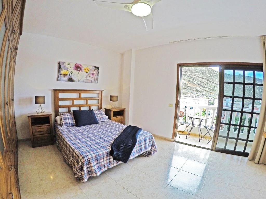 a bedroom with a bed and a balcony at Casa El Cercado in Santa Cruz de Tenerife