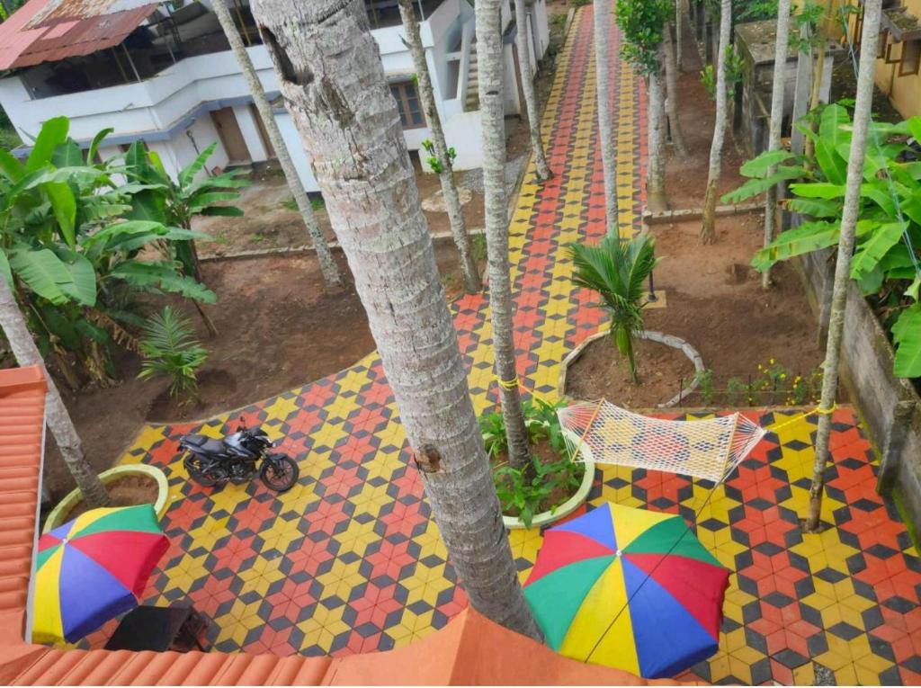 an overhead view of a sidewalk with umbrellas on the ground at SEVENSTAR RESIDENCY in Varkala