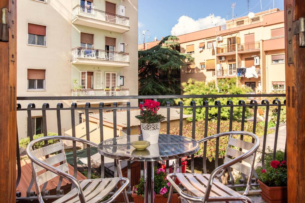 a glass table and chairs on a balcony at Plaza Rooms Ciampino in Ciampino