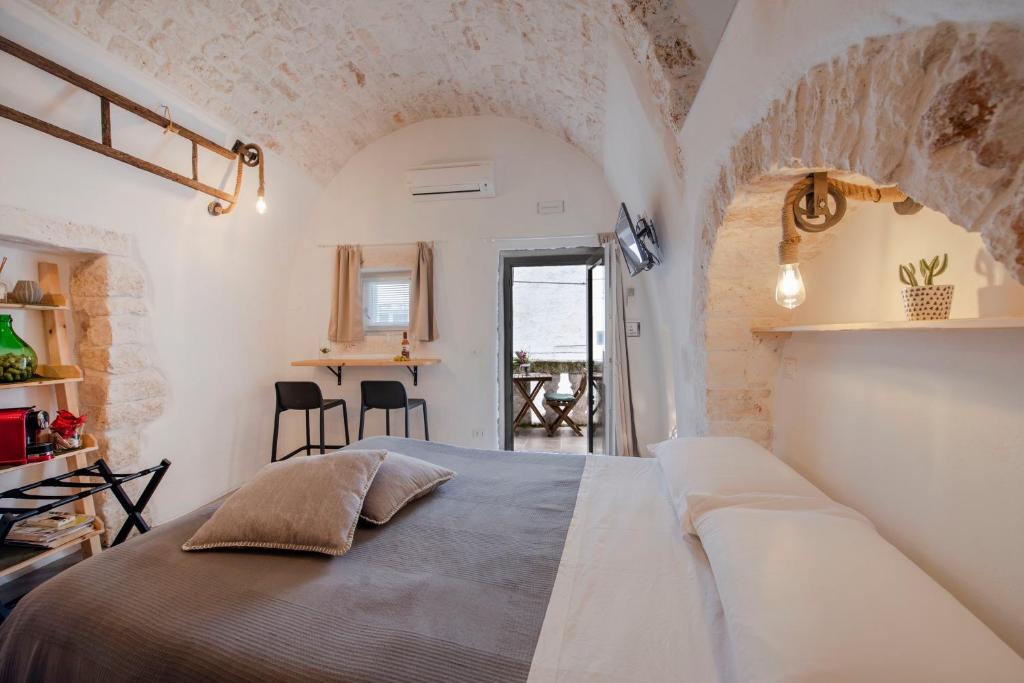 a bedroom with a bed and a chair in it at CASA FLAMI' in Ostuni