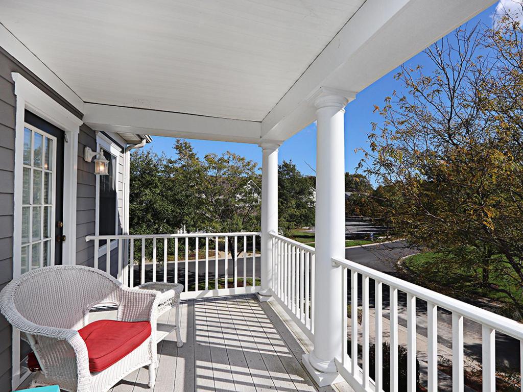 a white porch with a chair and a window at Bear Trap Dunes - 96 Willow Oak in Ocean View