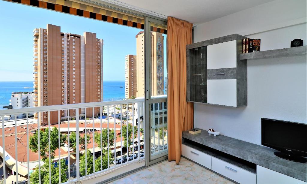 a room with a large window with a view of the ocean at Albatros 13-1 in Benidorm