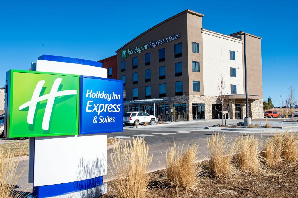 a building with a sign for the hilton express and suites at Holiday Inn Express & Suites - Colorado Springs AFA Northgate, an IHG Hotel in Colorado Springs
