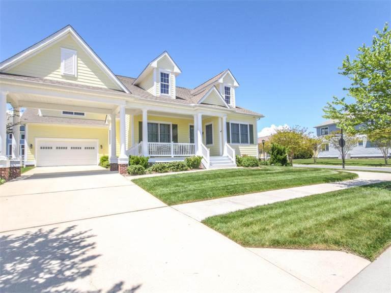 a large white house with a driveway at Bayside Resort - 36486 Wild Rose in Selbyville