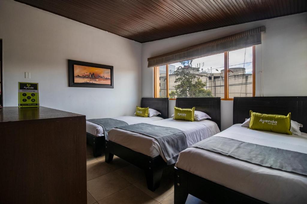 Postel nebo postele na pokoji v ubytování Ayenda 1087 La Estacion