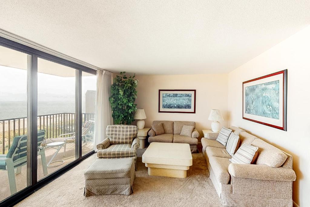 a living room with a couch and chairs and a balcony at Sea Colony Edgewater House IV in Bethany Beach