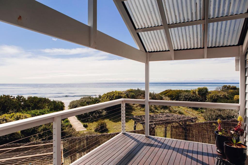 
a view from a balcony of a balcony overlooking the ocean at Beach Break in Turners Beach
