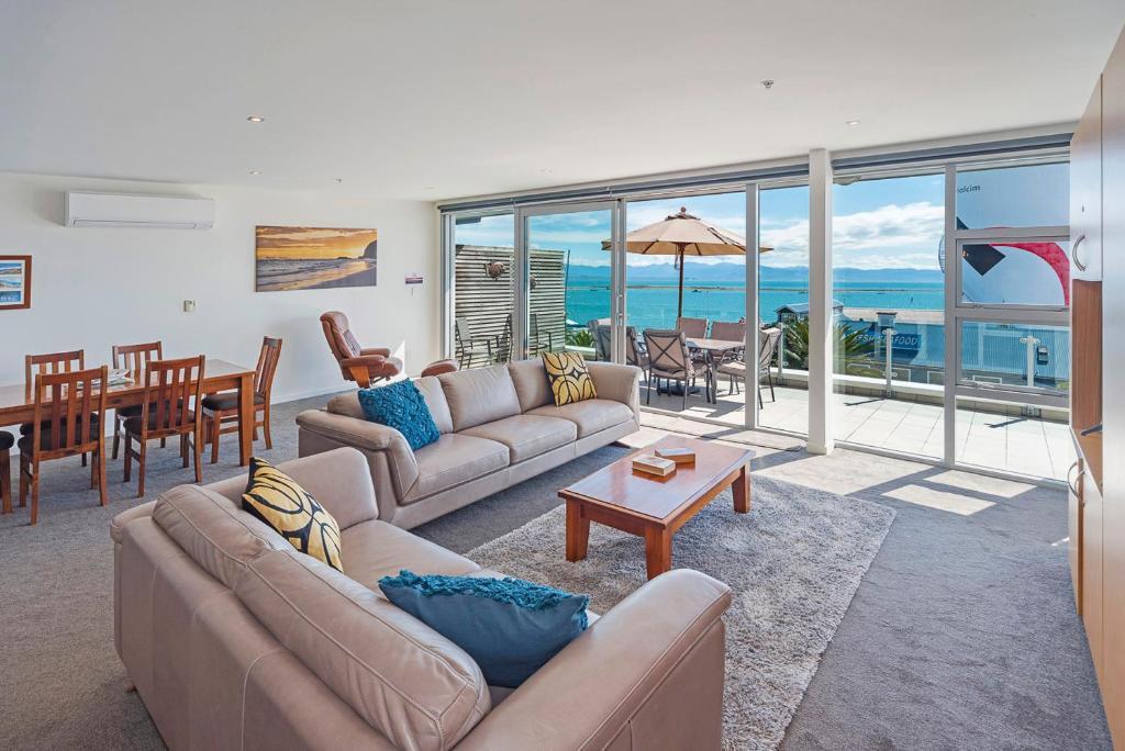 a living room with a couch and a table at Sea Quest Apartment in Nelson