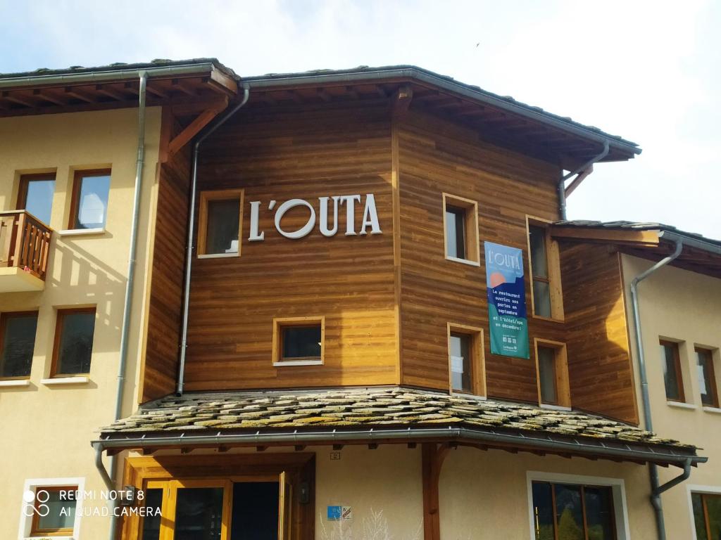 a building with the word la tour written on it at L'Outa Hotel Restaurant in Termignon