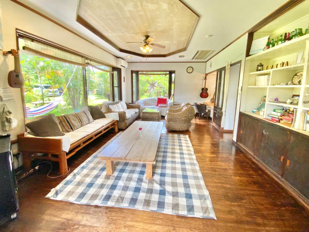 a living room with a couch and a table at イリワ -stay&coffee iriwa- in Ishigaki Island