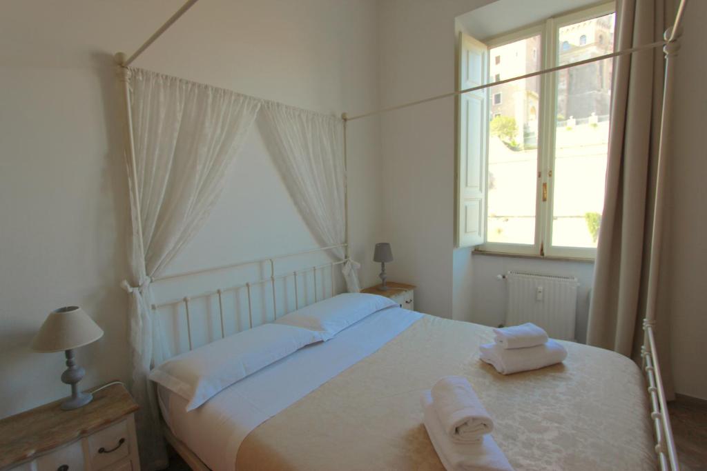 a bedroom with a bed with two towels on it at Art Atelier San Pietro in Rome