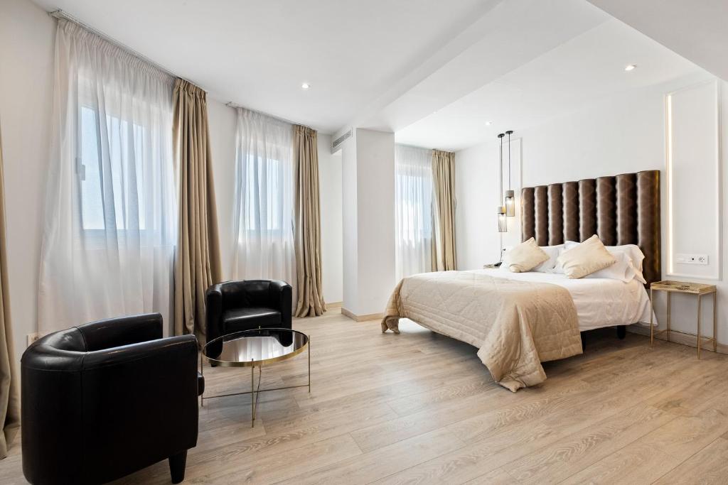 a bedroom with a large bed and a chair at Urban Anaga Hotel in Santa Cruz de Tenerife