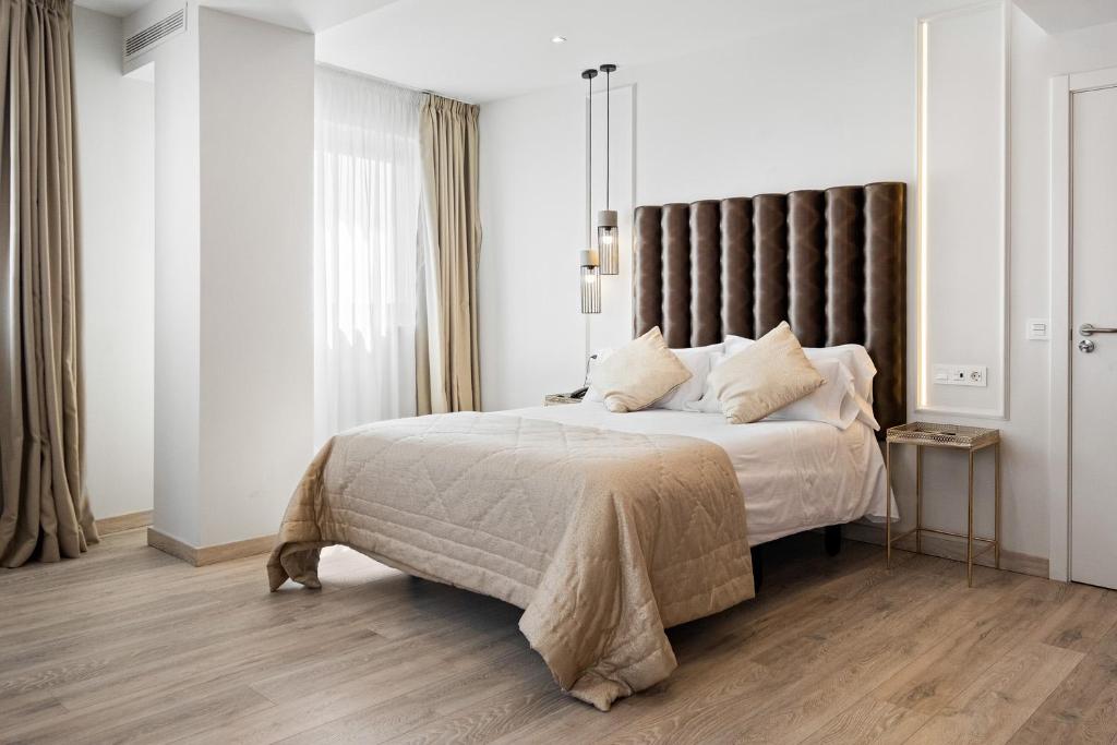 1 dormitorio con 1 cama grande y cabecero marrón en Urban Anaga Hotel, en Santa Cruz de Tenerife