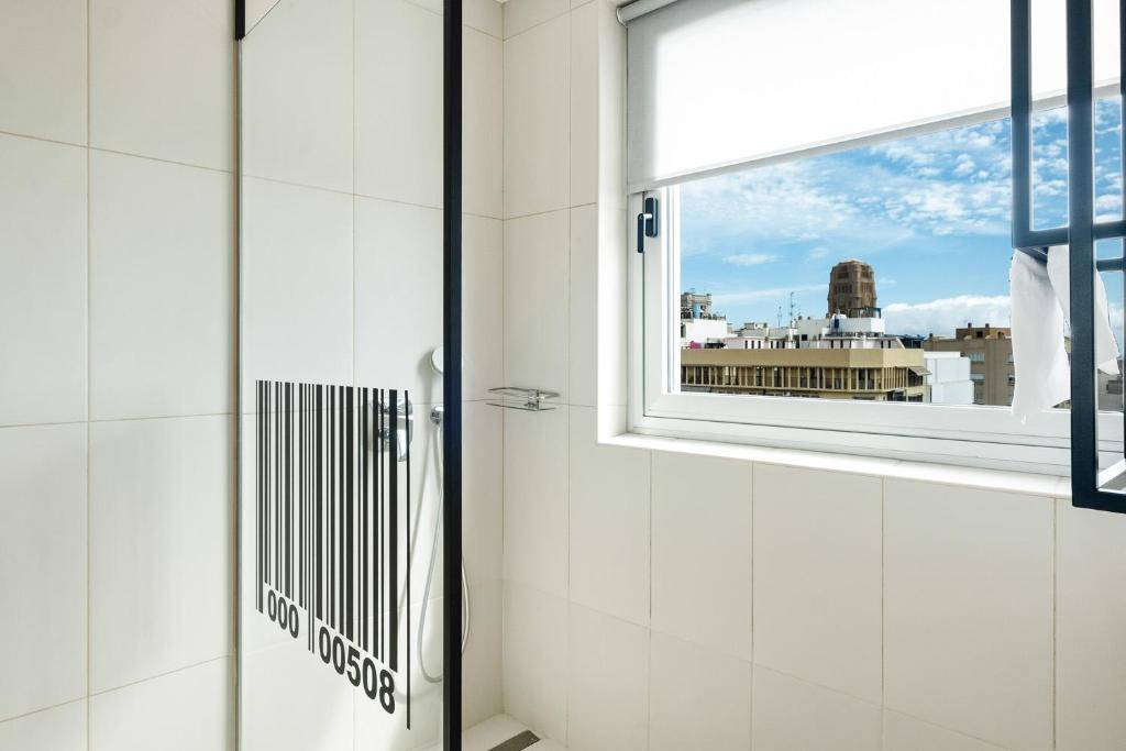 a window in a bathroom with a view of the city at Urban Anaga Hotel in Santa Cruz de Tenerife