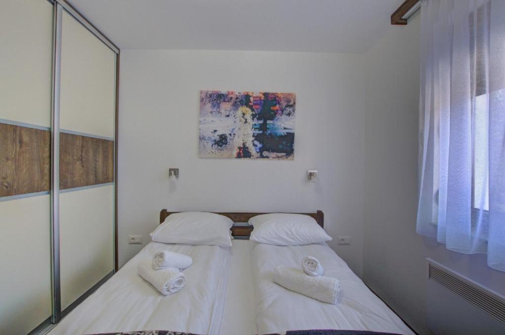 two beds in a bedroom with a mirror at Gorštak-Šeha in Jahorina