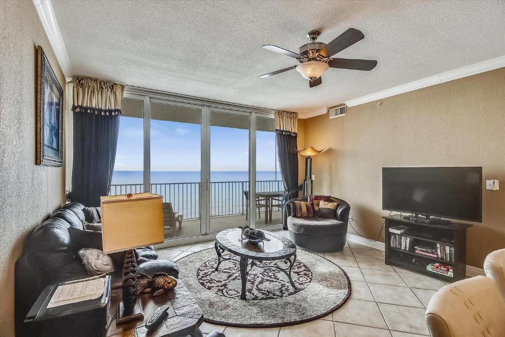 a living room with a couch and a television and a table at San Carlos Unit 902 in Gulf Shores