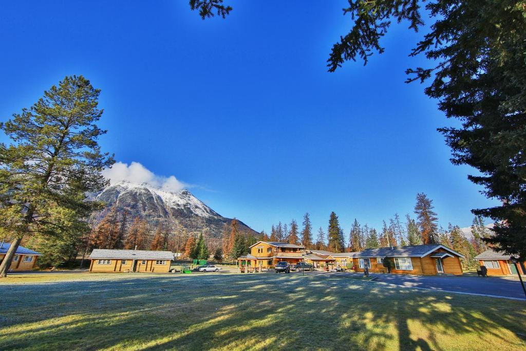 a view of a mountain with a house and trees at Jasper House Bungalows in Jasper