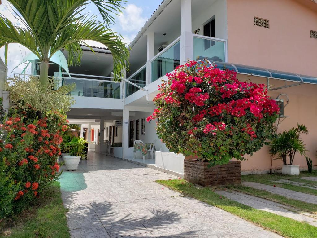 a large building with flowers in front of it at Pousada Privê Maré Alta in Porto De Galinhas
