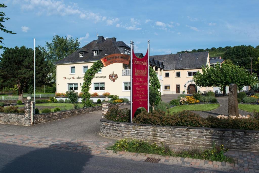 a building with a red sign in front of it at Ferienwohnung Römerweinhof in Neumagen-Dhron