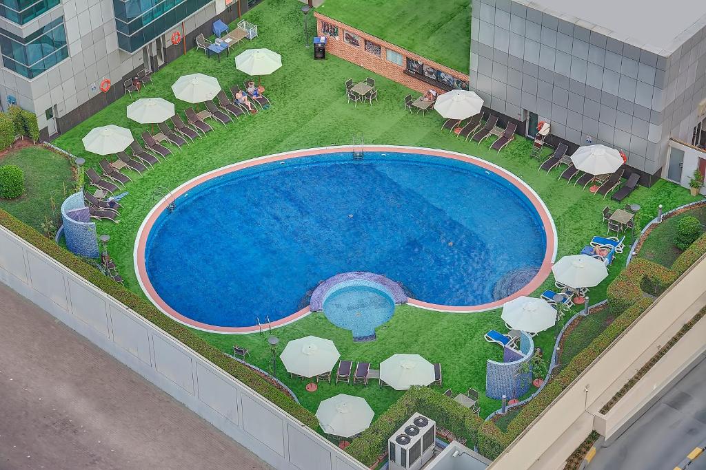an overhead view of a pool with chairs and umbrellas at Marina View Deluxe Hotel Apartment in Dubai