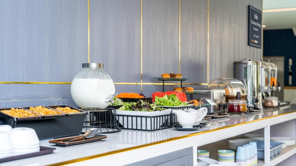 a buffet line with various food items on it at Tree Tara hotel in Lampang