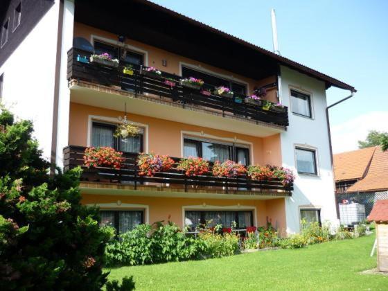 a building with flower boxes on the balconies at Ferienwohnung am Ludwigstein in Spiegelau
