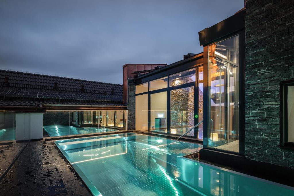 a swimming pool in the middle of a house at Hotel-Gasthof Höttl in Deggendorf