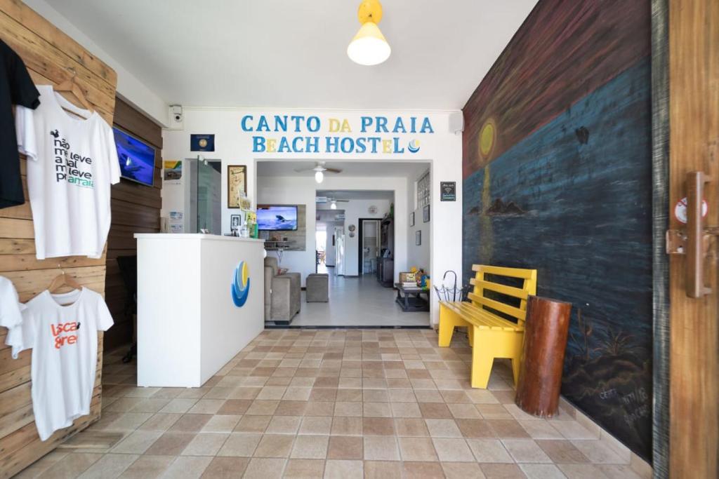 a corridor of a hospital with a room with a door at Canto da Praia Suítes in Arraial do Cabo