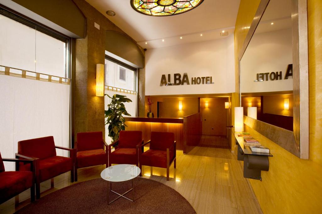 a lobby of aaa motel with chairs and a table at Alba Hotel in Barcelona