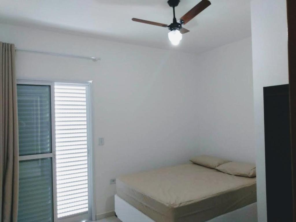 En eller flere senge i et værelse på Condomínio Villagio II