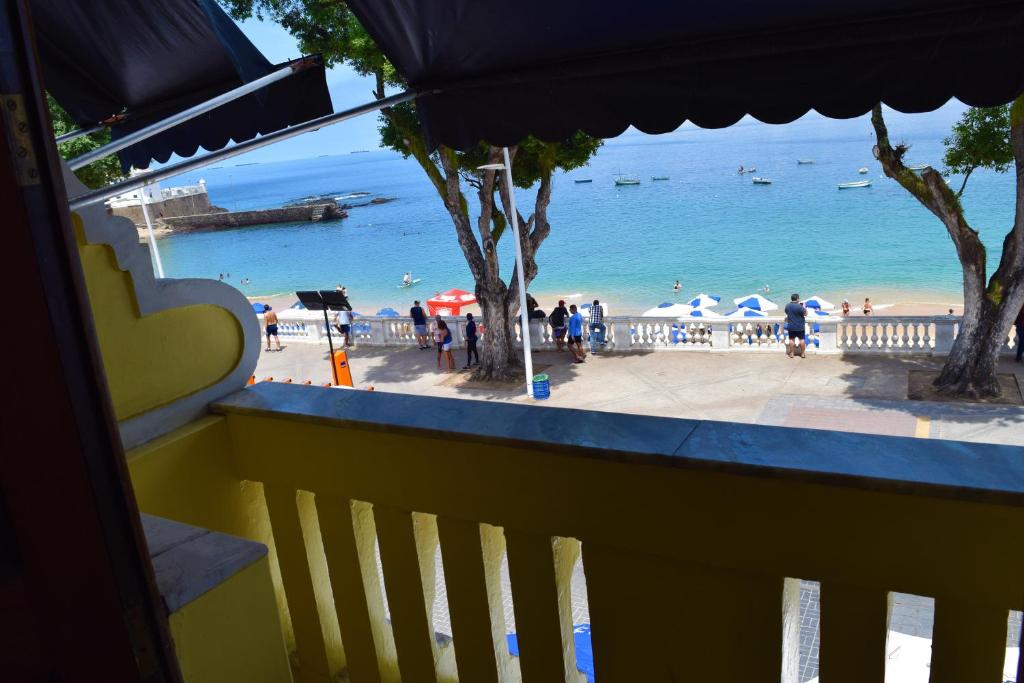 a view of the beach from the balcony of a resort at Beach Front Village in Salvador