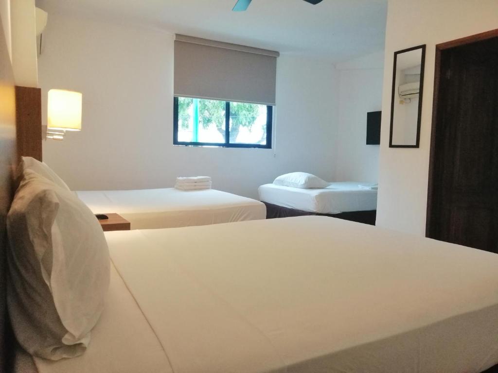 Postel nebo postele na pokoji v ubytování Buenavista Place Hotel
